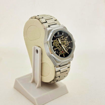 Angled front shot of silver skeleton-style dial watch showcasing sleek case edges and polished finish