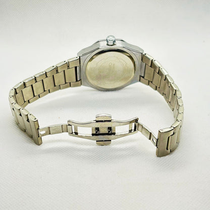 Back view of silver-tone men's watch showing solid stainless steel caseback and bracelet links